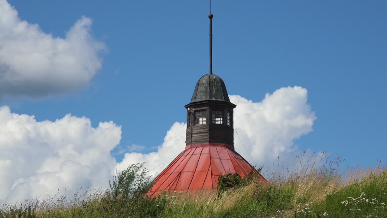 A tilting up close-up view of the tower of Museum fortress Korela, Russia