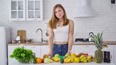 pretty woman in her kitchen. portrait of smiling young housewife in modern kitchen