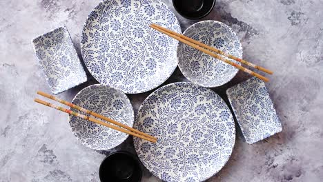 Empty-oriental-style-dishware-set-on-gray-stone-background