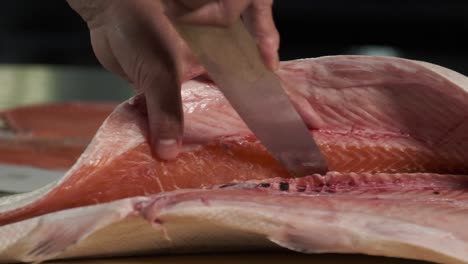 Chef-preparing-fresh-salmon-in-the-kitchen