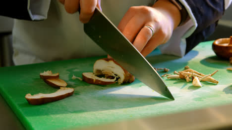 chef cutting mushroom in kitchen 4k