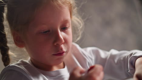 pretty little artist draws and breaks crayon lead at table