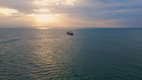 aerial ship sailing sunset. vessel floating on calm surface ocean at evening.