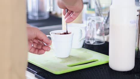 stirring and mixing instant coffee in a mug