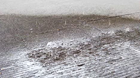 Detail-of-soapy-water-falling-on-hydraulic-concrete-floor-at-a-construction-site-in-slow-motion