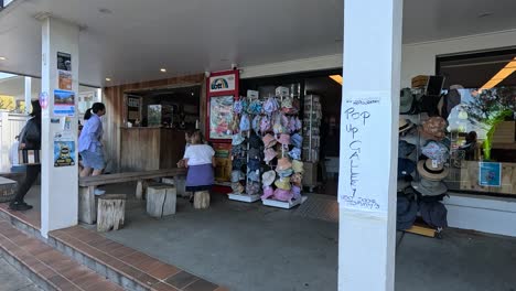 people browsing and buying items at a beach shop