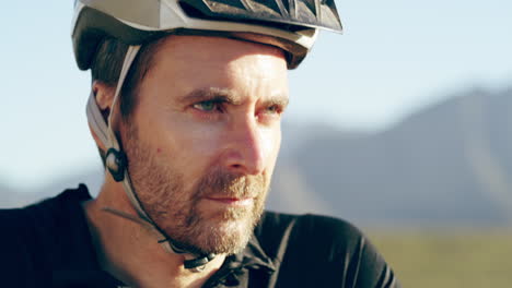 man cycling in mountains