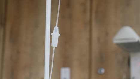 plastic drop counter hanging and waving. equipment in delivery room. blurred backdrop.