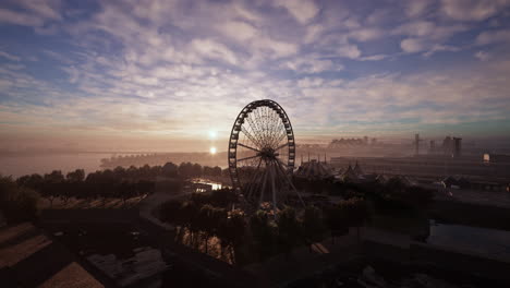 aerial view of ferris wheel at amusement park during sunset