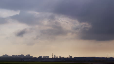 airplane taking off over a city at sunset