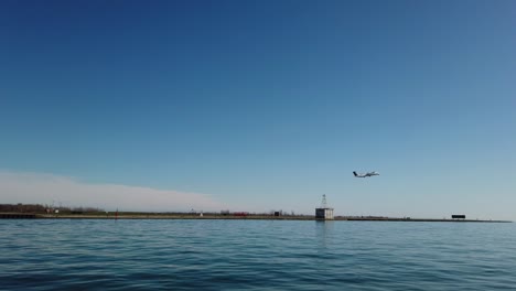 Wide-shot-of-small-plane-taking-off-from-city-airport-in-Toronto