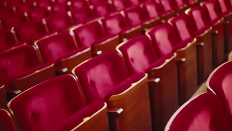 slow dreamy movement over empty red concert seats in movie theatre