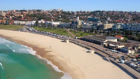 Paisaje-De-La-Playa-De-Bondi-Con-Poca-Gente,-A-La-Vista-Está-El-Paisaje-Urbano-De-Sydney-En-Nueva-Gales-Del-Sur,-Australia-Durante-El-Día---Toma-Aérea-De-Drones