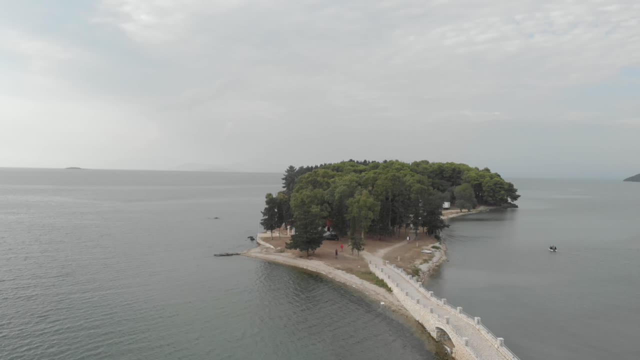 aerial drone footage of exotic greek tiny island Koukoumitsa Vonitsa, linked with bridge road with mainland , establishment shot