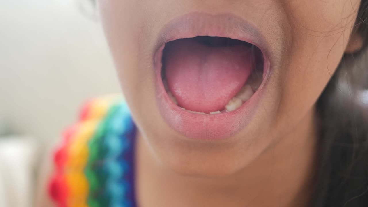 Close-up of a Child's Open Mouth Showing Tongue and Teeth