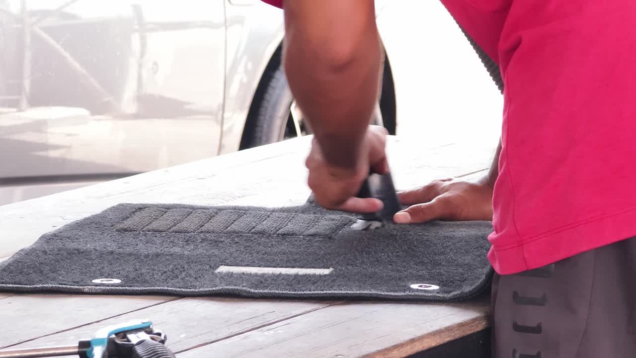 Cleaning and repairing a car floor mat