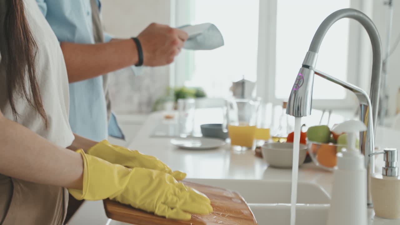 Latin Couple Talking While Washing Dishes