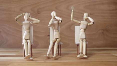 Wooden-figurines-embody-the-proverbial-principle-of-see-no-evil,-speak-no-evil,-hear-no-evil-on-wood