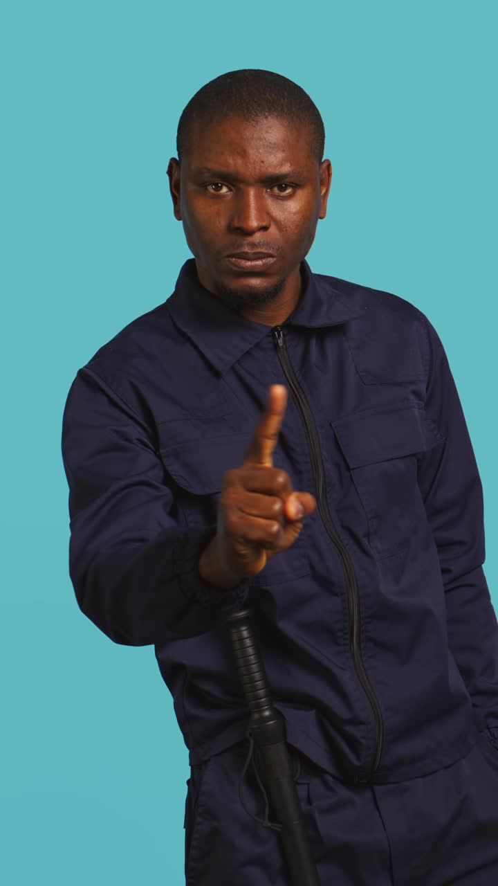 African American Security Officer Waving Finger in Disapproval