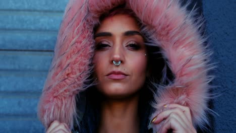 woman with nose ring and fur jacket standing outside the shop 4k