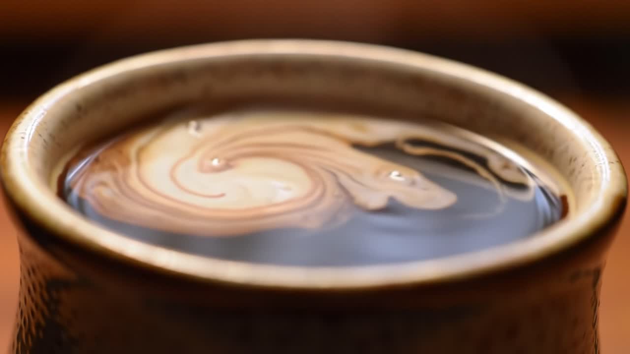A Close-Up Exploration of Swirling Patterns in a Steaming Cup of Liquid, Capturing the Unexpected Beauty of Everyday Moments