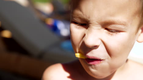 Kid-having-snack-with-french-fries-at-the-beach