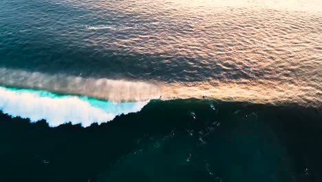 vista aérea de la ola rompiendo cerca de los surfistas en la playa de los negros