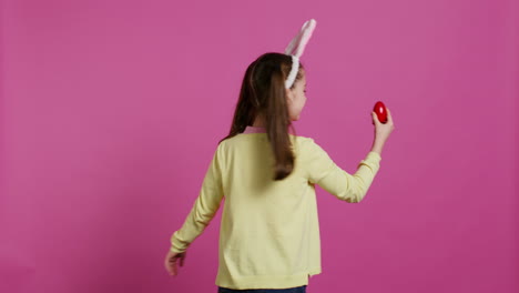 enthusiastic small child spinning around in front of camera,