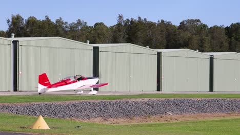 a red and white plane takes off