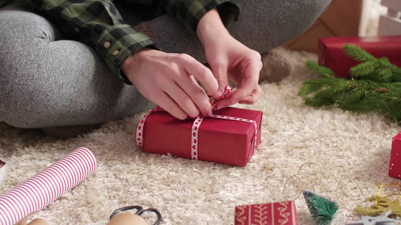 Woman's hands wrapping the christmas presents