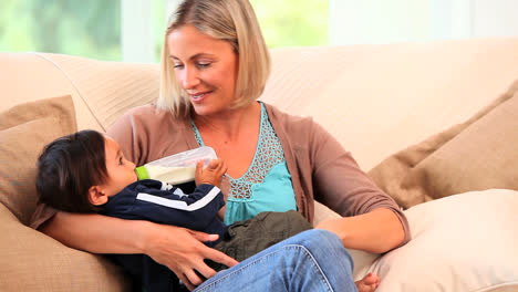 Relaxed-mother-bottlefeeding-her-child-