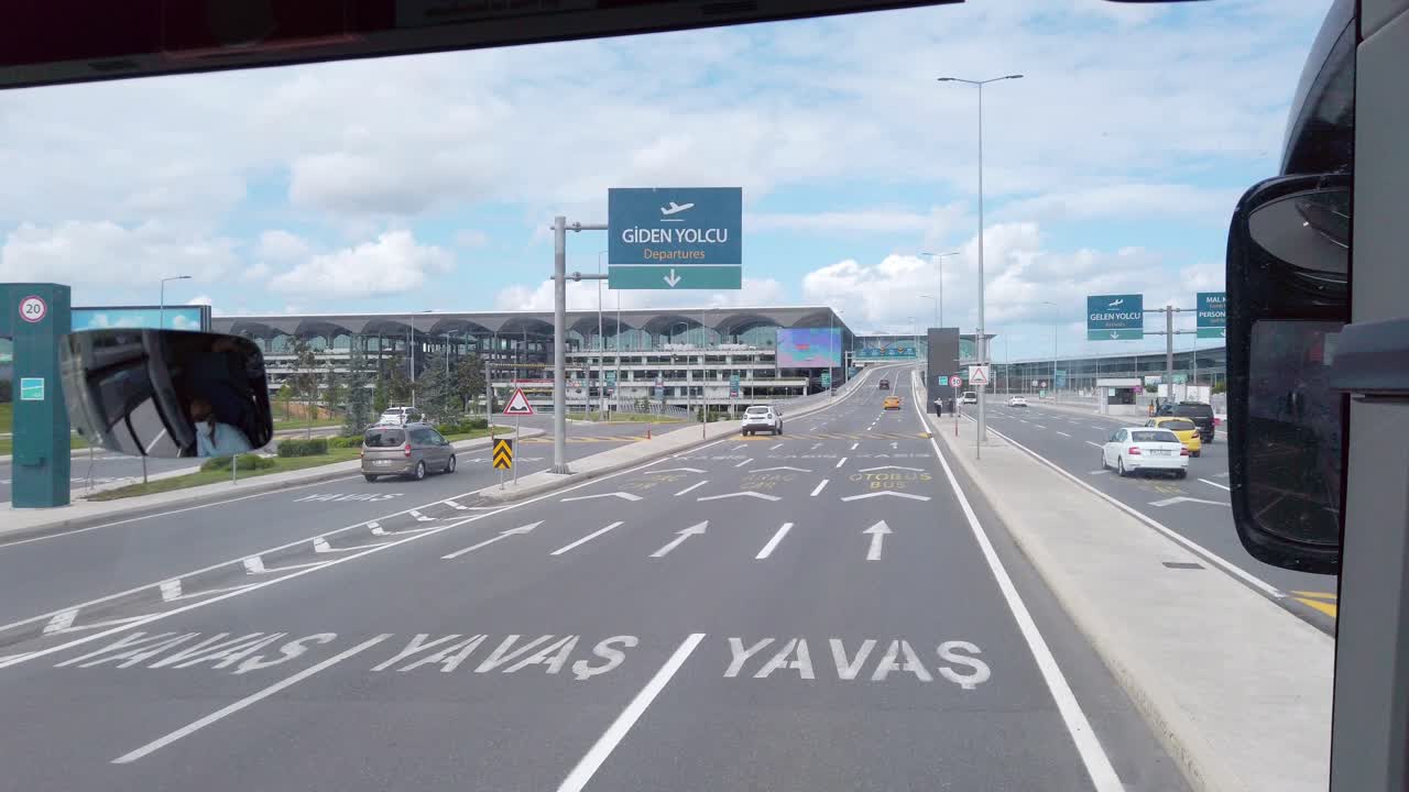 Daytime, on a partly cloudy day, a shot from a bus approaching Istanbul Airport's terminal