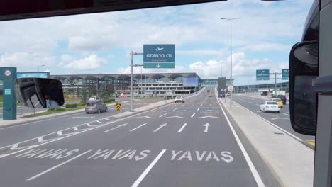 daytime, on a partly cloudy day, a shot from a bus approaching istanbul airport's terminal