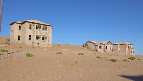 exterior establishing shot of abandoned buildings in the namib desert at the ghost town of kolmanskop namibia 3