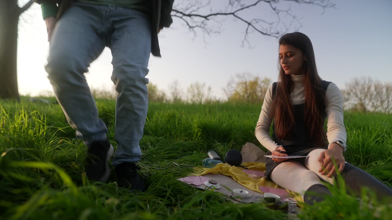 Woman meditating in nature with tarot cards