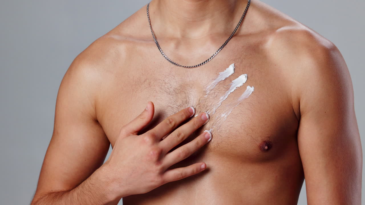 Man applying cream on his chest