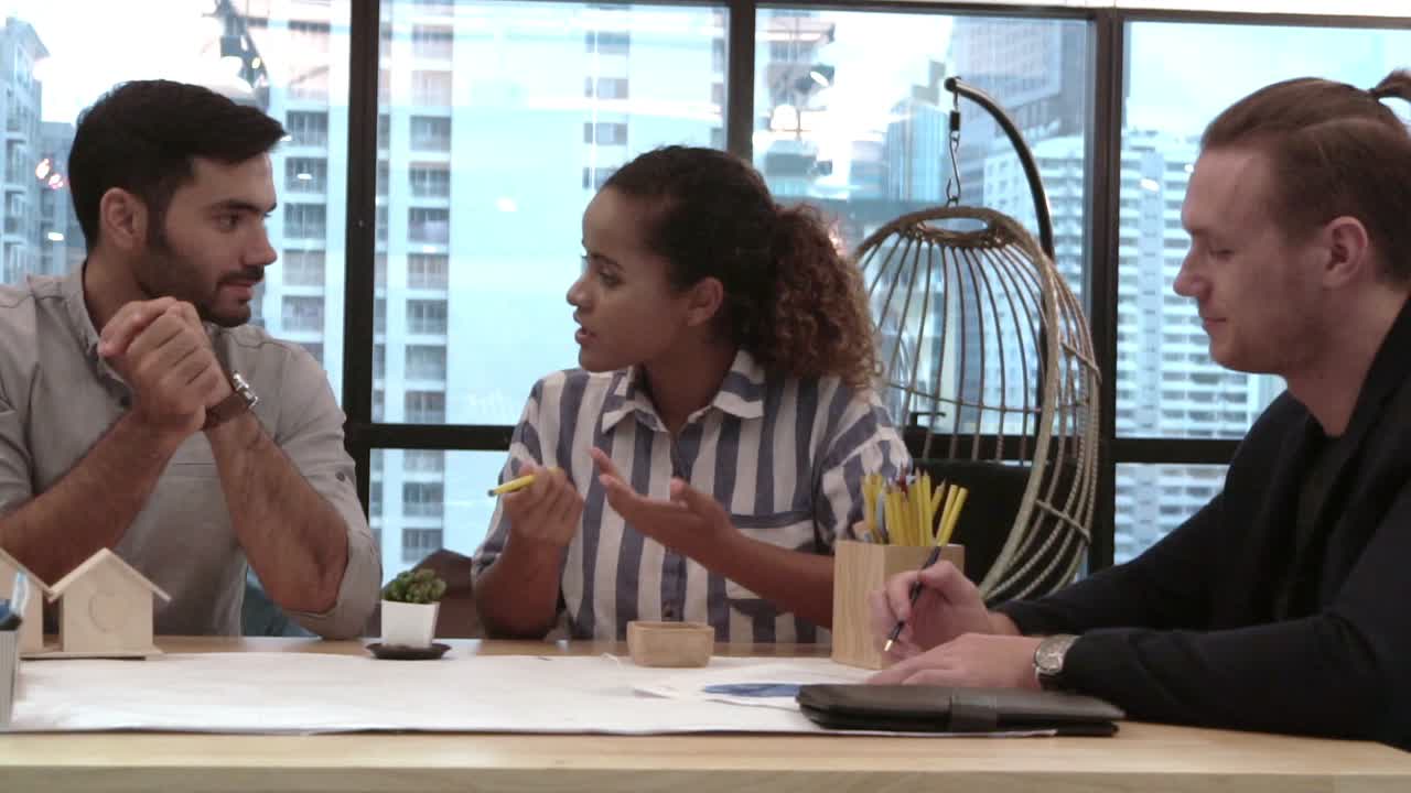 Creative business people group having conversation at office desk in workplace.