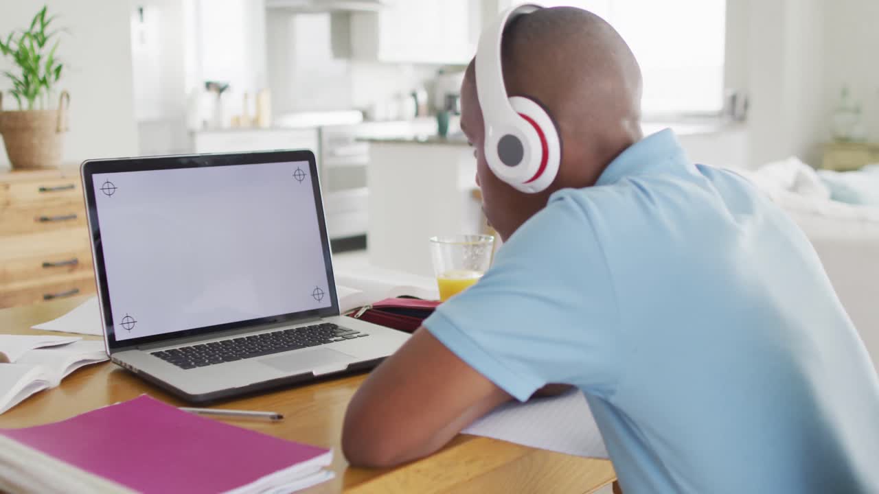 video de un niño afroamericano enfocado con una computadora portátil con espacio de copia teniendo lecciones en línea en casa
