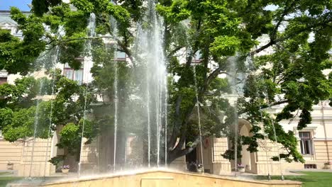 Fountain-in-front-of-City-Hall-of-Iasi-Romania-on-a-sunny-day-filmed-in-slow-motion