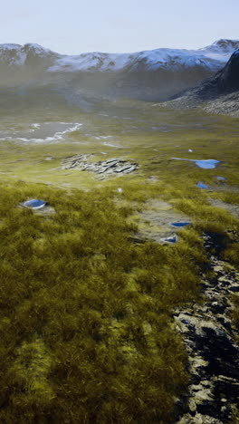Vast mountainous landscape with green valleys and reflections in water bodies