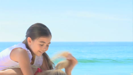 Mother-and-daughter-playing-on-a-beach