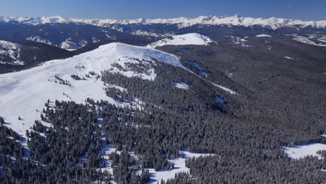 backcountry winter vail pass colorado aerial drone i70 rocky mountains landscape ptarmigan hill mount of the holy cross sunny morning blue sky fresh snow snowboard ski snowmobile forward pan up reveal