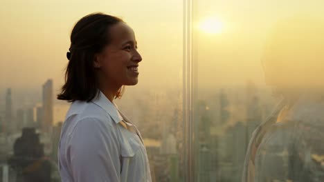 slow motion shot of a tourist taking in the views over downtown bangkok at sunset