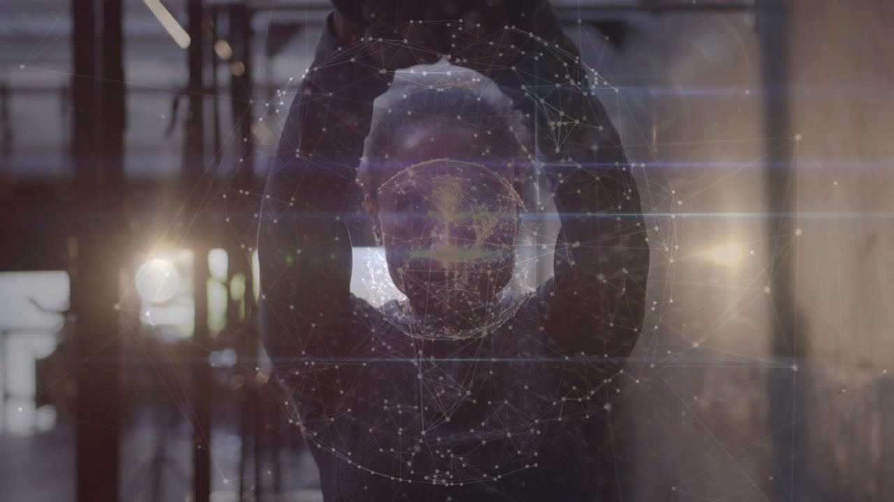 Woman raising hands behind glass in tech demo, aligning with particle sphere and brightening nodes