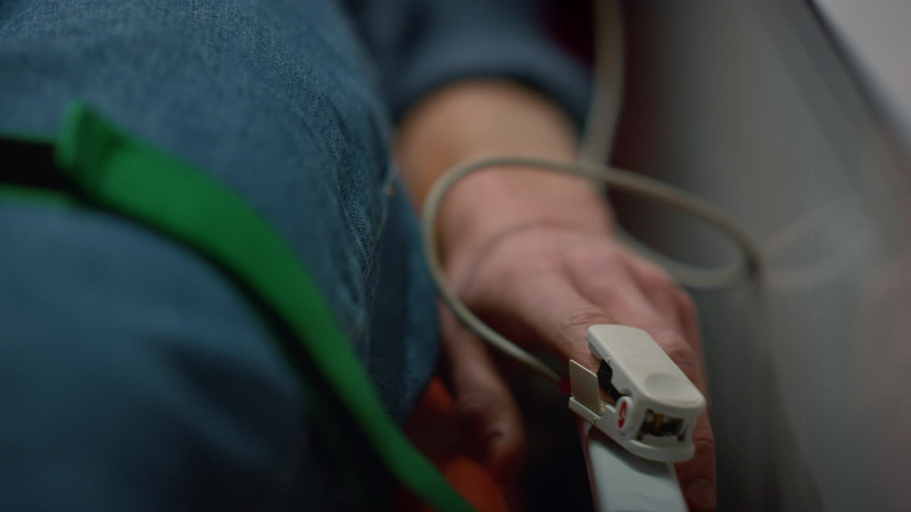 Man patient checking patient oxygen blood level with oximeter in ambulance car