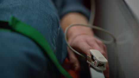 Man-patient-checking-patient-oxygen-blood-level-with-oximeter-in-ambulance-car