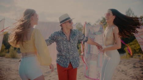 happy man spinning female friends while dancing