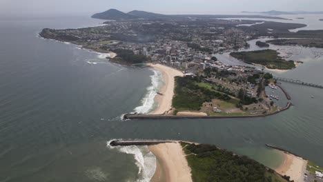 forster breakwater and smith point at coolongolook river mouth in mid north coast of new south wales in australia. aerial pullback shot