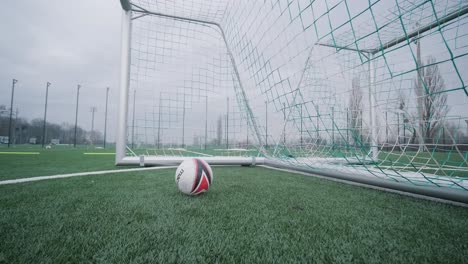 a children's football team trains at the stadium under the guidance of a coach. kids in sports uniforms practice ball exercises, improve technique, and develop teamwork on the green field