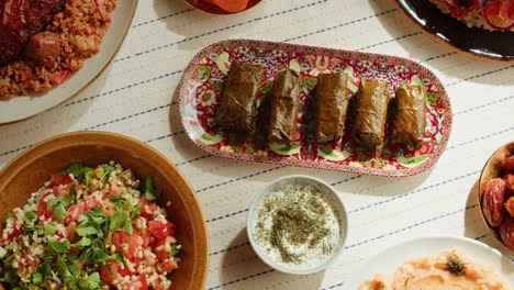 family dinner with dolmas and other middle eastern dishes